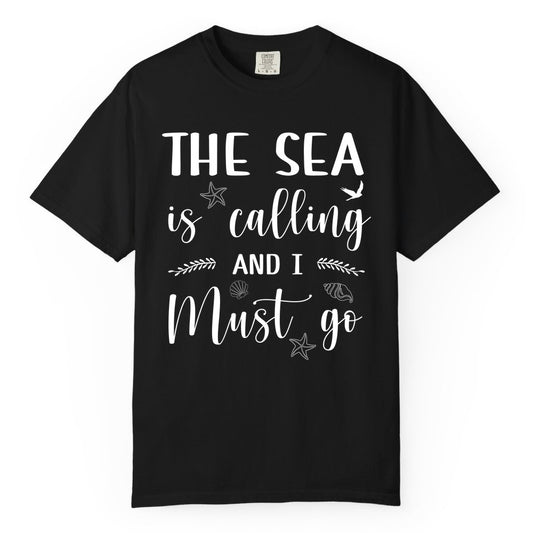The Sea Is Calling Shirt - Ocean Lover Apparel Beach Vacation Tee (Comfort Color) in Black - The Sea Is Calling Shirt - Ocean Typography With Shells and Starfish