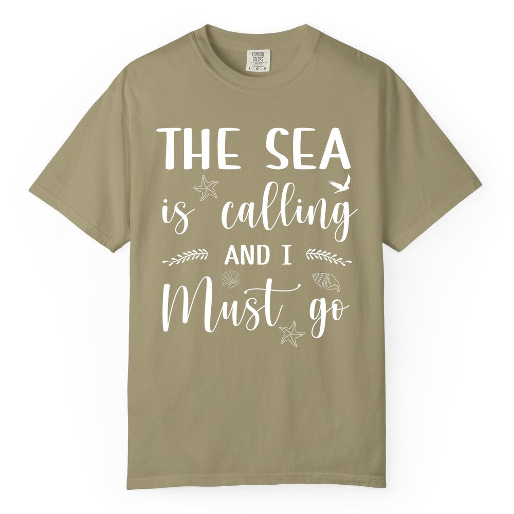 The Sea Is Calling Shirt - Ocean Lover Apparel Beach Vacation Tee (Comfort Color) in Khaki - The Sea Is Calling Shirt - Ocean Typography With Shells and Starfish