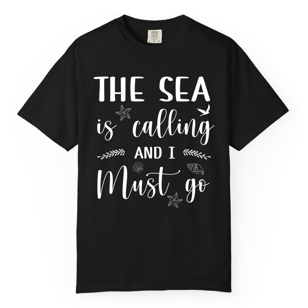 The Sea Is Calling Shirt - Ocean Lover Apparel Beach Vacation Tee (Comfort Color) in Black - The Sea Is Calling Shirt - Ocean Typography With Shells and Starfish