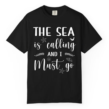 The Sea Is Calling Shirt - Ocean Lover Apparel Beach Vacation Tee (Comfort Color) in Black - The Sea Is Calling Shirt - Ocean Typography With Shells and Starfish
