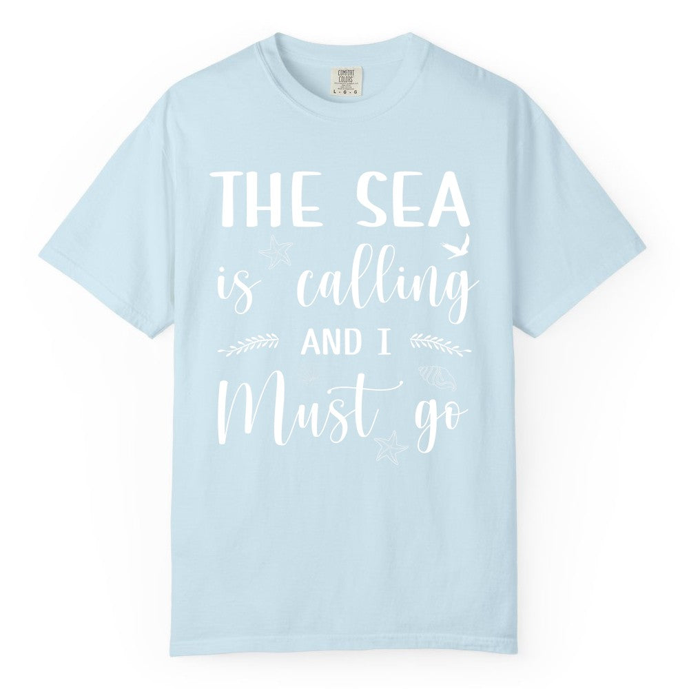 The Sea Is Calling Shirt - Ocean Lover Apparel Beach Vacation Tee (Comfort Color) in Chambray - The Sea Is Calling Shirt - Ocean Typography With Shells and Starfish
