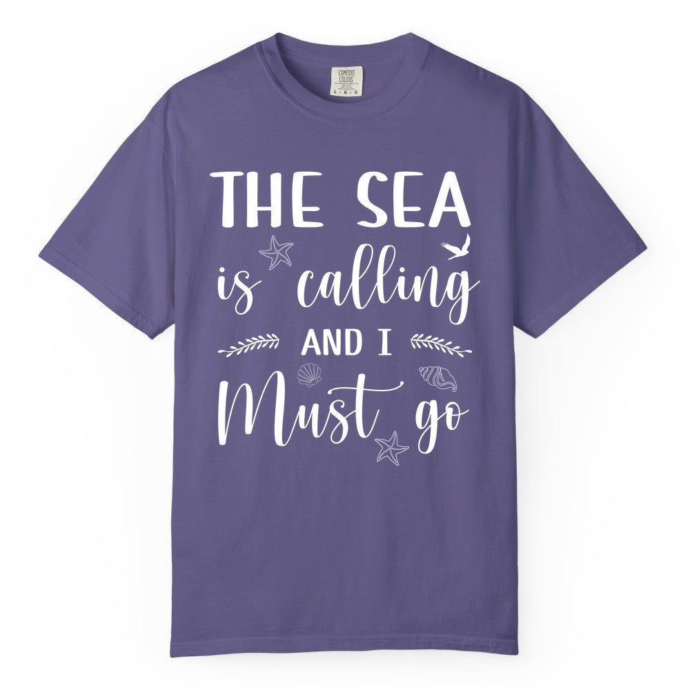 The Sea Is Calling Shirt - Ocean Lover Apparel Beach Vacation Tee (Comfort Color) in Grape - The Sea Is Calling Shirt - Ocean Typography With Shells and Starfish