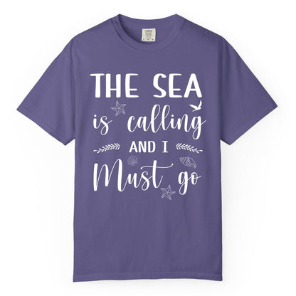 The Sea Is Calling Shirt - Ocean Lover Apparel Beach Vacation Tee (Comfort Color) in Grape - The Sea Is Calling Shirt - Ocean Typography With Shells and Starfish