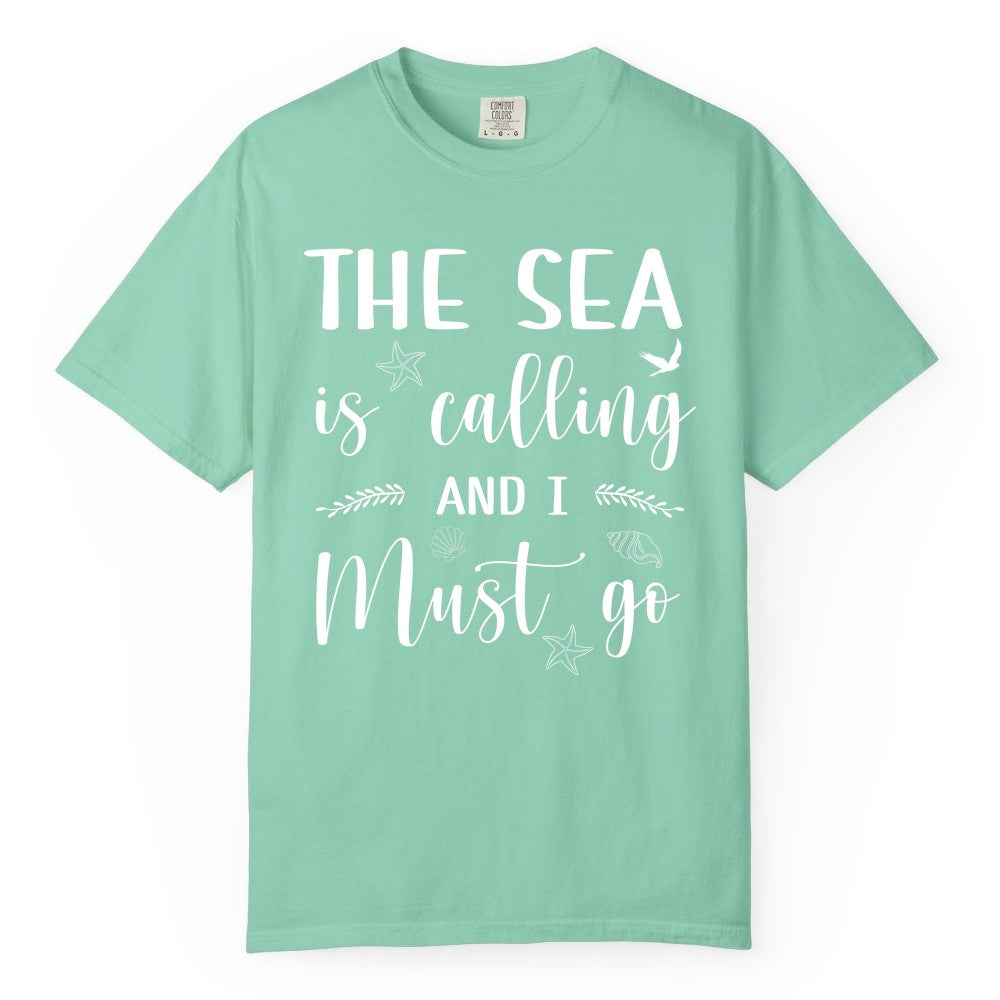 The Sea Is Calling Shirt - Ocean Lover Apparel Beach Vacation Tee (Comfort Color) in Island Reef - The Sea Is Calling Shirt - Ocean Typography With Shells and Starfish