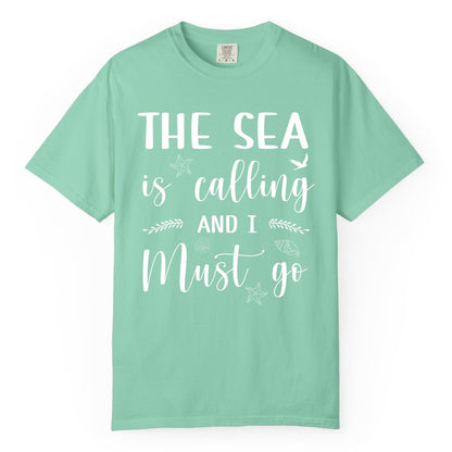 The Sea Is Calling Shirt - Ocean Lover Apparel Beach Vacation Tee (Comfort Color) in Island Reef - The Sea Is Calling Shirt - Ocean Typography With Shells and Starfish