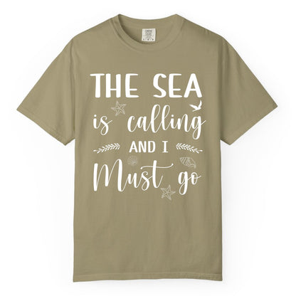 The Sea Is Calling Shirt - Ocean Lover Apparel Beach Vacation Tee (Comfort Color) in Khaki - The Sea Is Calling Shirt - Ocean Typography With Shells and Starfish
