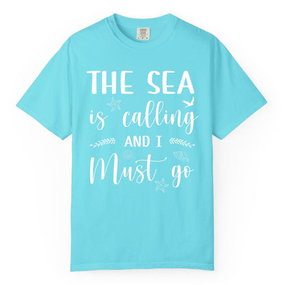 The Sea Is Calling Shirt - Ocean Lover Apparel Beach Vacation Tee (Comfort Color) in Lagoon Blue - The Sea Is Calling Shirt - Ocean Typography With Shells and Starfish