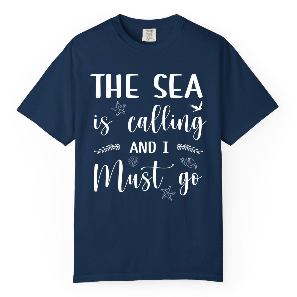 The Sea Is Calling Shirt - Ocean Lover Apparel Beach Vacation Tee (Comfort Color) in Navy - The Sea Is Calling Shirt - Ocean Typography With Shells and Starfish