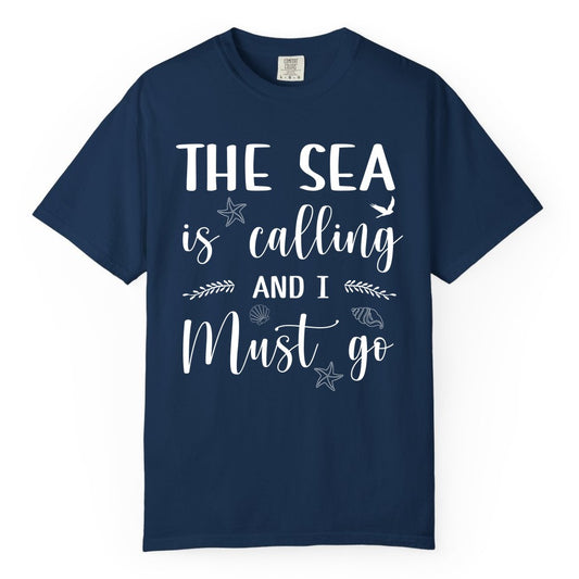 The Sea Is Calling Shirt - Ocean Lover Apparel Beach Vacation Tee (Comfort Color) in Navy - The Sea Is Calling Shirt - Ocean Typography With Shells and Starfish