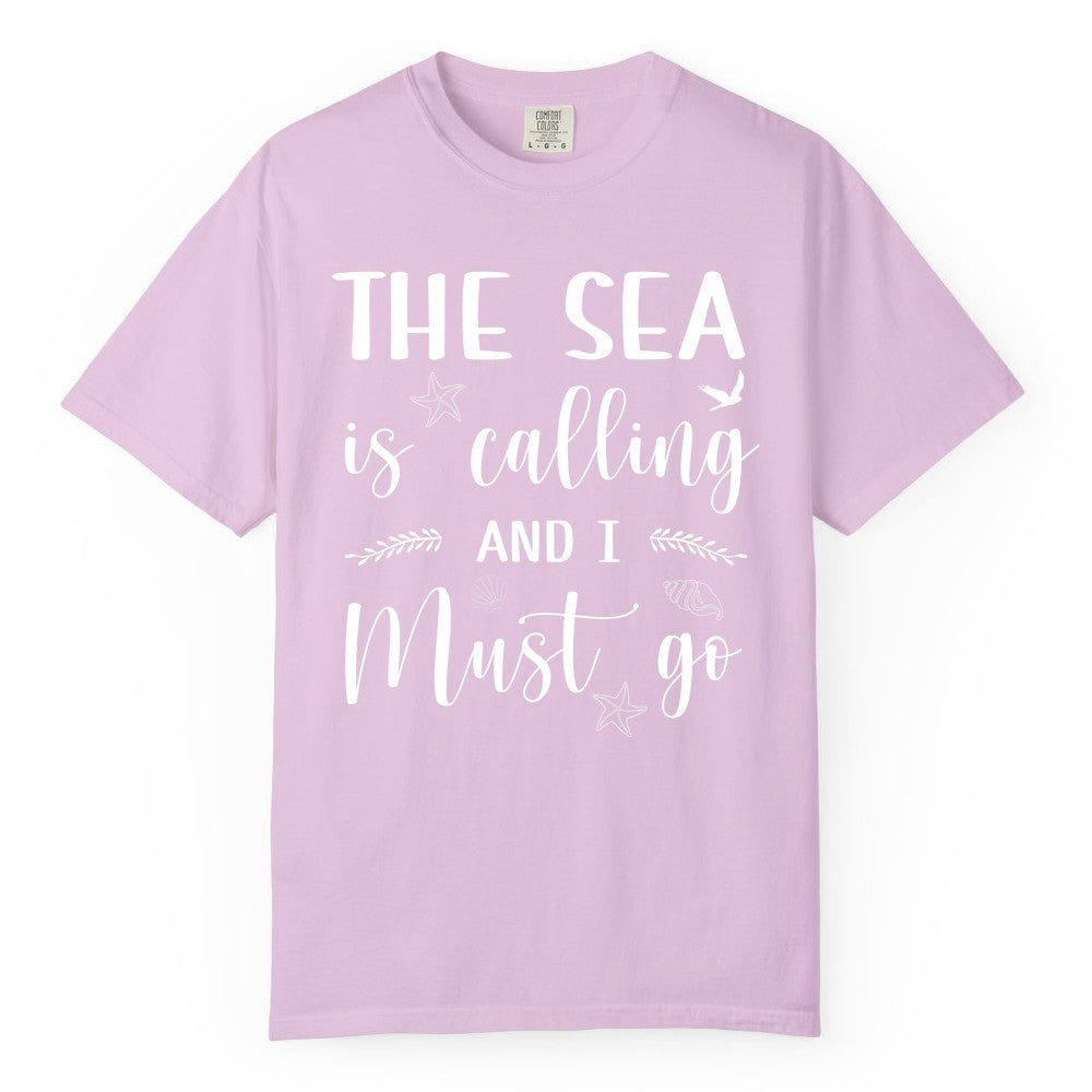 The Sea Is Calling Shirt - Ocean Lover Apparel Beach Vacation Tee (Comfort Color) in Orchid - The Sea Is Calling Shirt - Ocean Typography With Shells and Starfish