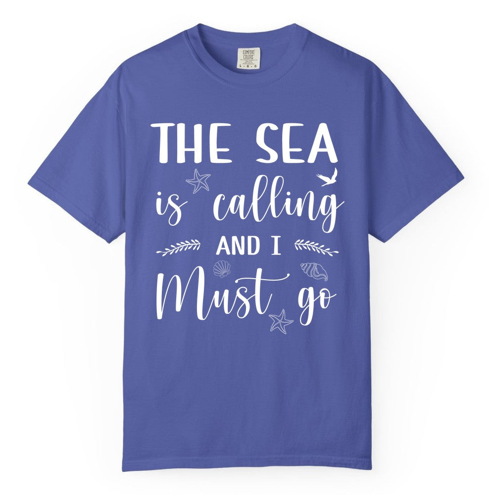 The Sea Is Calling Shirt - Ocean Lover Apparel Beach Vacation Tee (Comfort Color) in Periwinkle - The Sea Is Calling Shirt - Ocean Typography With Shells and Starfish