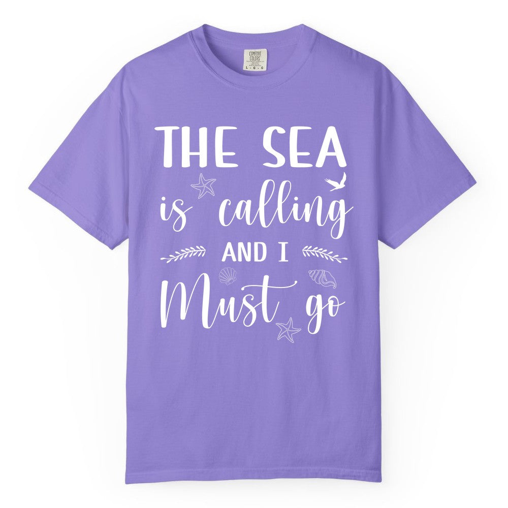 The Sea Is Calling Shirt - Ocean Lover Apparel Beach Vacation Tee (Comfort Color) in Violet - The Sea Is Calling Shirt - Ocean Typography With Shells and Starfish